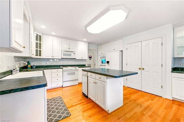 1904 Sandee Cres, Virginia Beach, VA 23454 - kitchen featuring white appliances, dark countertops, white cabinets, backsplash, and light wood finished floors