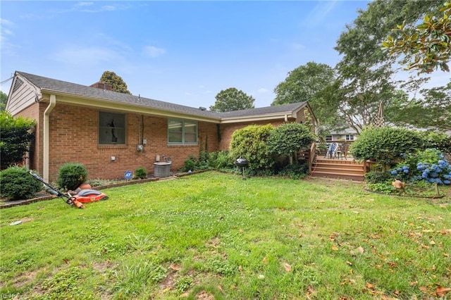 701 Milton Dr, Hampton, VA 23666 - rear view of house with brick siding, a yard, and a deck