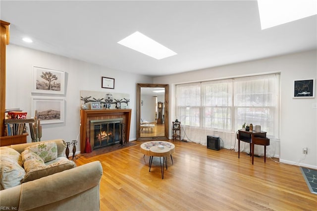 701 Milton Dr, Hampton, VA 23666 - living area featuring a skylight, light wood finished floors, a glass covered fireplace, and recessed lighting