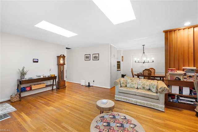 701 Milton Dr, Hampton, VA 23666 - living area with a skylight, a chandelier, and light wood-style flooring