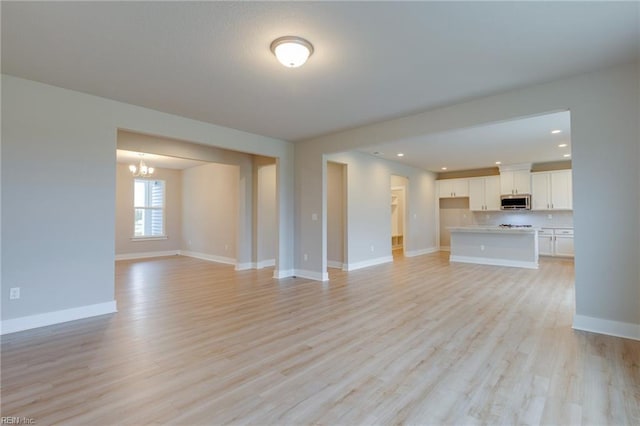 1501 Cedarville Ct, Chesapeake, VA 23322 - unfurnished living room with a chandelier, light wood-type flooring, and recessed lighting