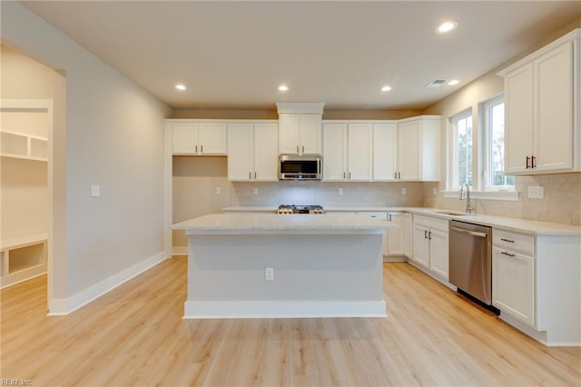 1501 Cedarville Ct, Chesapeake, VA 23322 - kitchen with appliances with stainless steel finishes, backsplash, light wood-type flooring, white cabinets, and recessed lighting