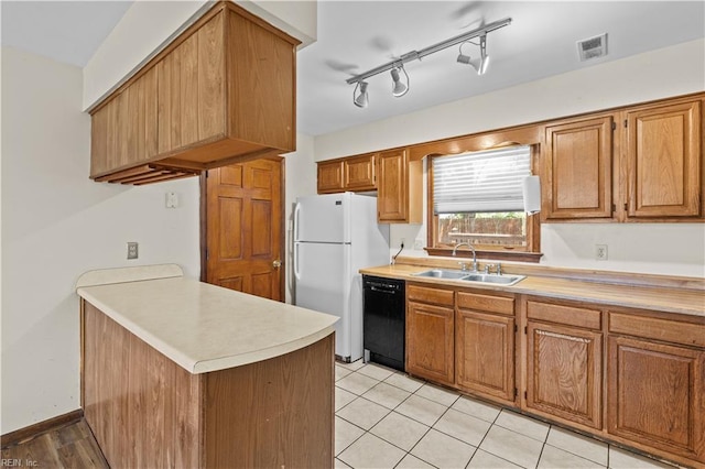 128 Glen Echo Dr, Norfolk, VA 23505 - kitchen with black dishwasher, freestanding refrigerator, light countertops, and a peninsula