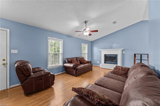 1801 Cougar Ct, Virginia Beach, VA 23456 - living area with light wood-style floors, a textured ceiling, ceiling fan, vaulted ceiling, and a fireplace
