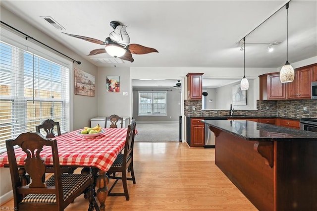 742 Milby Dr, Chesapeake, VA 23325 - kitchen with light wood finished floors, backsplash, a kitchen breakfast bar, and stainless steel appliances