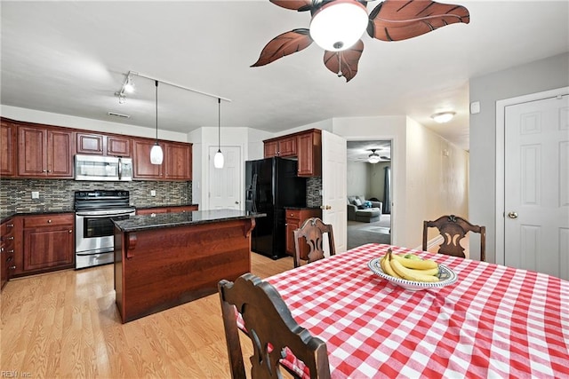 742 Milby Dr, Chesapeake, VA 23325 - kitchen with appliances with stainless steel finishes, a ceiling fan, a center island, backsplash, and light wood-type flooring