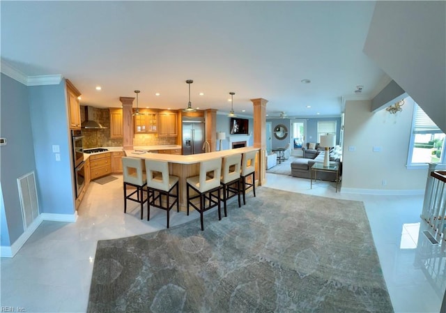 508 Virginia Dare Dr, Virginia Beach, VA 23451 - kitchen with appliances with stainless steel finishes, decorative columns, recessed lighting, wall chimney exhaust hood, and decorative backsplash