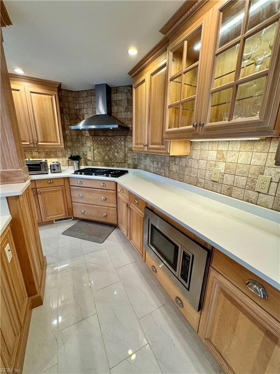 508 Virginia Dare Dr, Virginia Beach, VA 23451 - kitchen with wall chimney exhaust hood, gas cooktop, light marble finish floors, backsplash, and brown cabinets