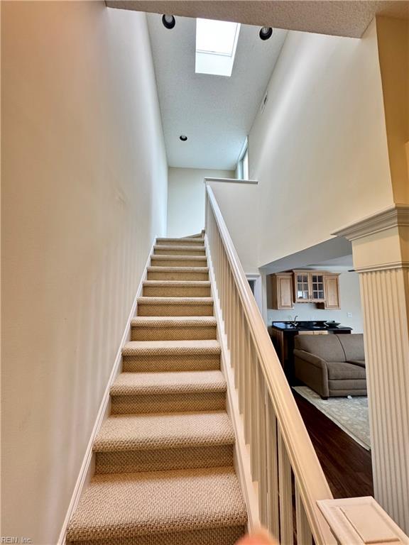 508 Virginia Dare Dr, Virginia Beach, VA 23451 - stairway featuring carpet floors, a towering ceiling, and recessed lighting