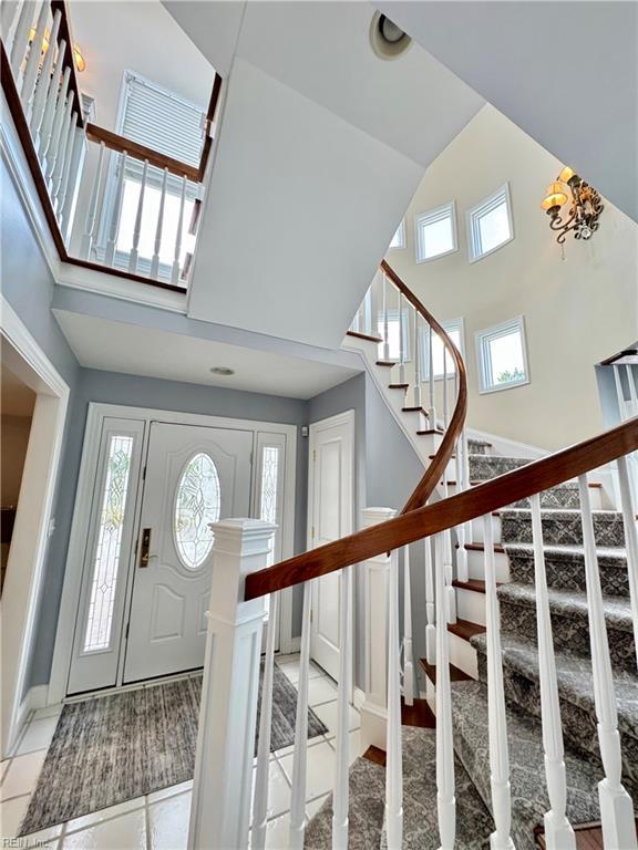 508 Virginia Dare Dr, Virginia Beach, VA 23451 - foyer with a high ceiling, stairway, and light tile patterned floors