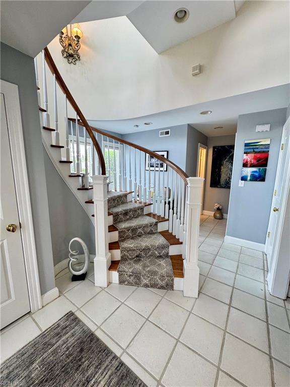 508 Virginia Dare Dr, Virginia Beach, VA 23451 - stairway featuring tile patterned floors and a chandelier