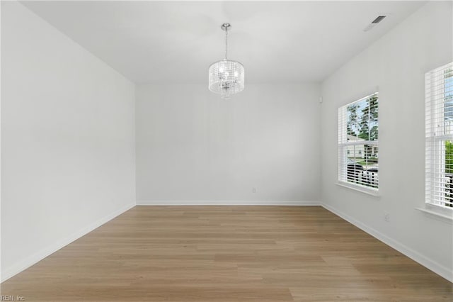 1506 Waltham Ln, Newport News, VA 23608 - spare room featuring a chandelier and light wood-style floors