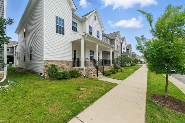 1506 Waltham Ln, Newport News, VA 23608 - view of front of home featuring covered porch, a residential view, and a front yard