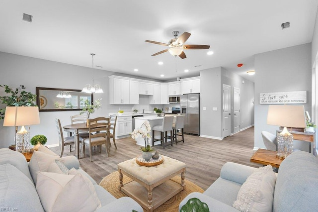31 Bank St, Windsor, VA 23487 - living area with a ceiling fan, light wood-style floors, a chandelier, and recessed lighting