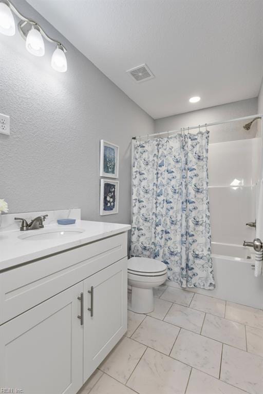 31 Bank St, Windsor, VA 23487 - full bathroom with shower / bath combo with shower curtain, vanity, marble look tiles, a textured wall, and recessed lighting