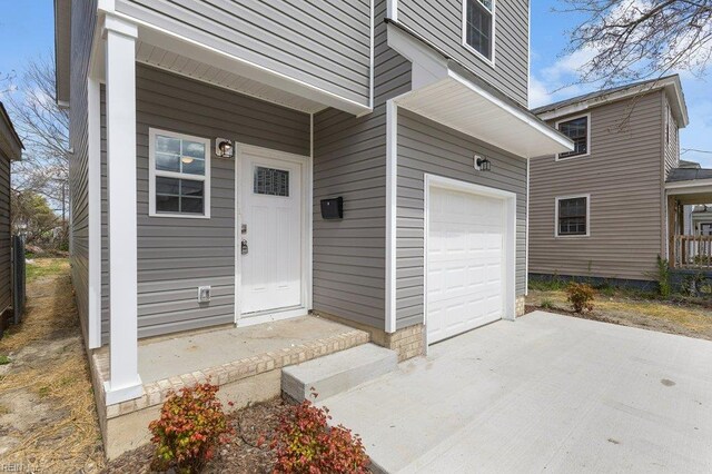 31 Bank St, Windsor, VA 23487 - entrance to property with an attached garage and concrete driveway