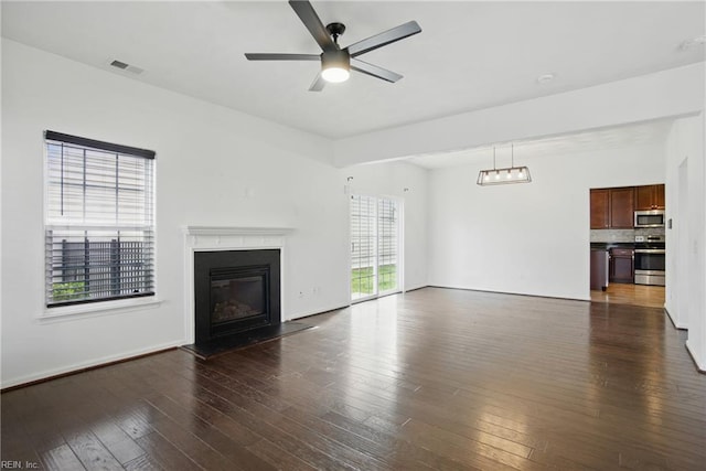 3494 Prices Fork Blvd, Suffolk, VA 23435 - unfurnished living room featuring dark wood-style floors, a glass covered fireplace, and a ceiling fan