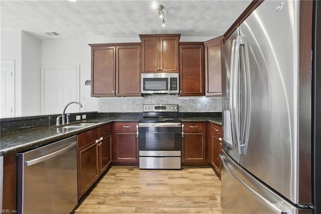 3494 Prices Fork Blvd, Suffolk, VA 23435 - kitchen featuring stainless steel appliances, light wood-style flooring, decorative backsplash, and dark stone counters