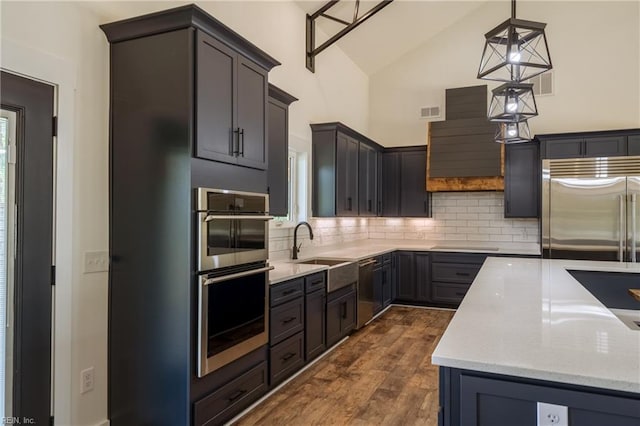 18052 Foxfire Trl, Windsor, VA 23487 - kitchen with stainless steel appliances, dark wood finished floors, decorative backsplash, high vaulted ceiling, and light stone countertops