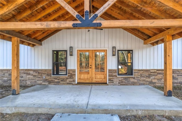 18052 Foxfire Trl, Windsor, VA 23487 - view of exterior entry with stone siding, board and batten siding, and french doors