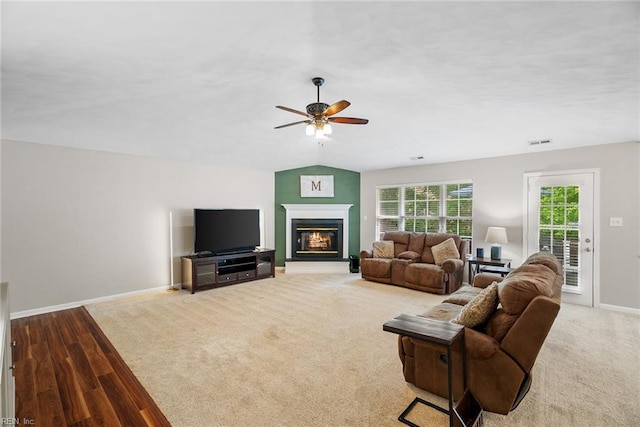 15110 Ashby Way, Carrollton, VA 23314 - living area featuring a ceiling fan, a glass covered fireplace, and wood finished floors