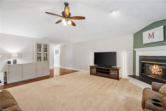 15110 Ashby Way, Carrollton, VA 23314 - carpeted living area with a ceiling fan, a glass covered fireplace, and vaulted ceiling