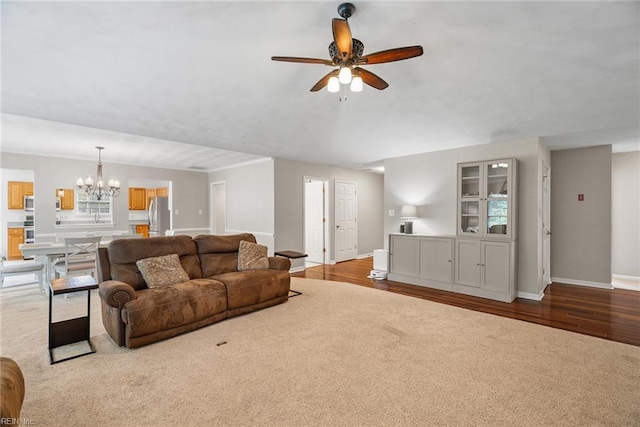 15110 Ashby Way, Carrollton, VA 23314 - living area featuring a chandelier, a ceiling fan, and wood finished floors