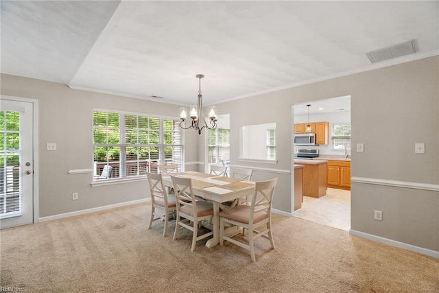 15110 Ashby Way, Carrollton, VA 23314 - dining space with a chandelier, light carpet, and crown molding