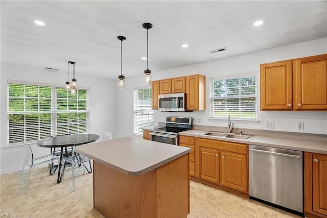 15110 Ashby Way, Carrollton, VA 23314 - kitchen with appliances with stainless steel finishes, recessed lighting, a center island, pendant lighting, and brown cabinets