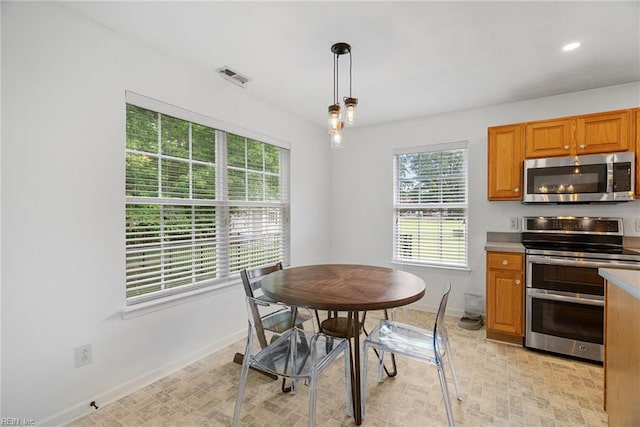 15110 Ashby Way, Carrollton, VA 23314 - kitchen featuring stainless steel appliances, hanging light fixtures, brown cabinetry, light countertops, and recessed lighting