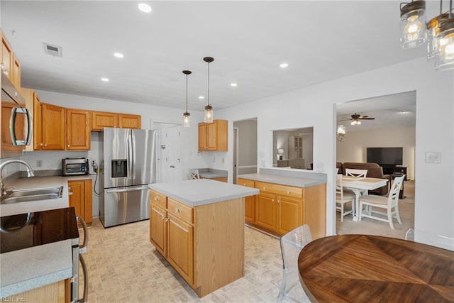 15110 Ashby Way, Carrollton, VA 23314 - kitchen with stainless steel appliances, ceiling fan, a center island, light countertops, and recessed lighting