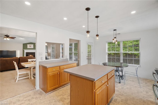 15110 Ashby Way, Carrollton, VA 23314 - kitchen with recessed lighting, a lit fireplace, a center island, decorative light fixtures, and light countertops
