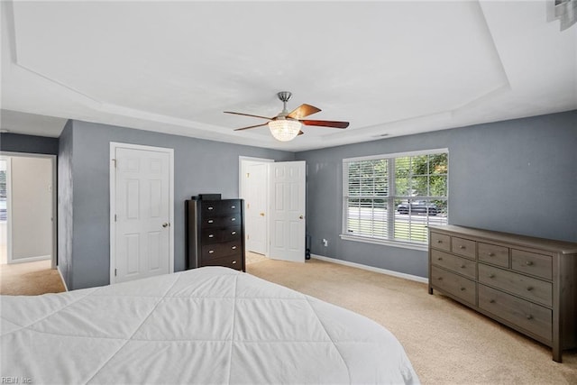 15110 Ashby Way, Carrollton, VA 23314 - bedroom featuring carpet floors, a tray ceiling, and a ceiling fan