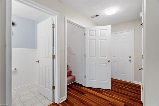 15110 Ashby Way, Carrollton, VA 23314 - corridor featuring wainscoting, wood finished floors, and stairs