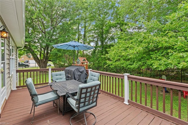 15110 Ashby Way, Carrollton, VA 23314 - wooden terrace with a fenced backyard, outdoor dining space, grilling area, and view of wooded area