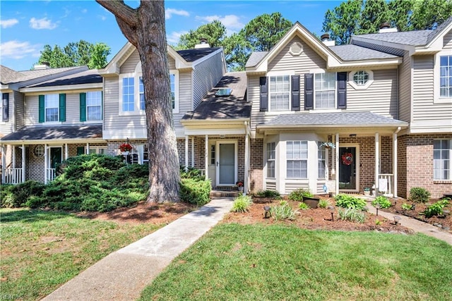 164 Corwin Cir, Hampton, VA 23666 - townhome / multi-family property featuring brick siding, a front lawn, and a shingled roof