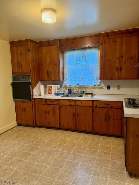 126 E Virginia Ave, Hampton, VA 23663 - kitchen featuring oven, stovetop, light countertops, and brown cabinetry