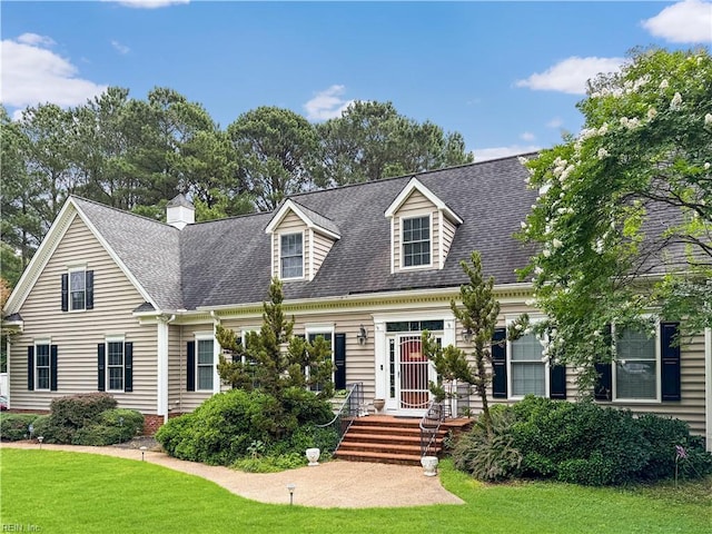 229 Skipjack Ln, Hallieford, VA 23068 - cape cod house with a front lawn, a shingled roof, and a chimney