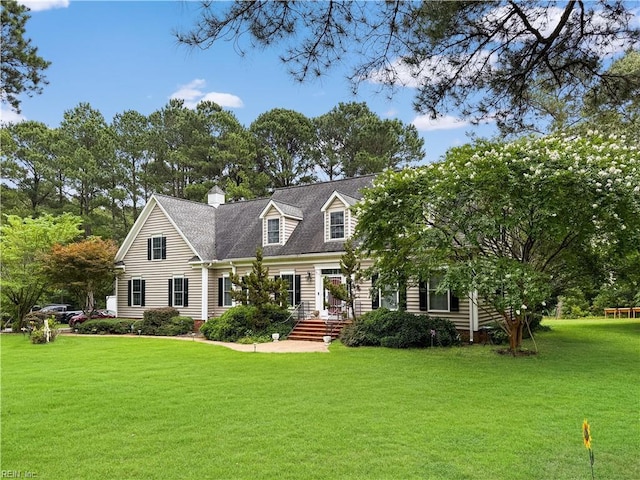 229 Skipjack Ln, Hallieford, VA 23068 - cape cod home with a front yard and a chimney