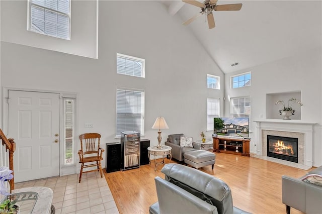 1010 Legends Way, Suffolk, VA 23435 - living room with high vaulted ceiling, a ceiling fan, a high end fireplace, and light wood-type flooring