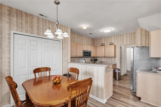 1010 Legends Way, Suffolk, VA 23435 - dining area with wallpapered walls, a chandelier, and light wood-type flooring