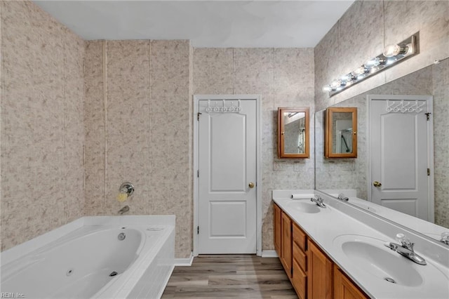 1010 Legends Way, Suffolk, VA 23435 - bathroom with a tub with jets, double vanity, and wood finished floors