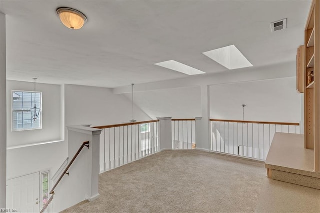 1010 Legends Way, Suffolk, VA 23435 - hallway with healthy amount of natural light, a skylight, carpet flooring, and lofted ceiling
