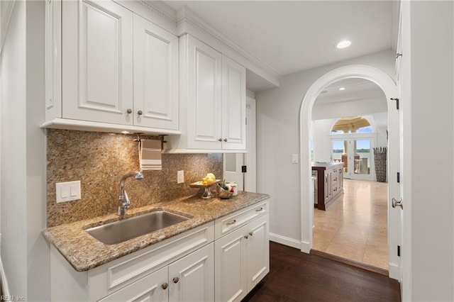 1845 N Alanton Dr, Virginia Beach, VA 23454 - kitchen with arched walkways, white cabinetry, recessed lighting, dark wood finished floors, and tasteful backsplash