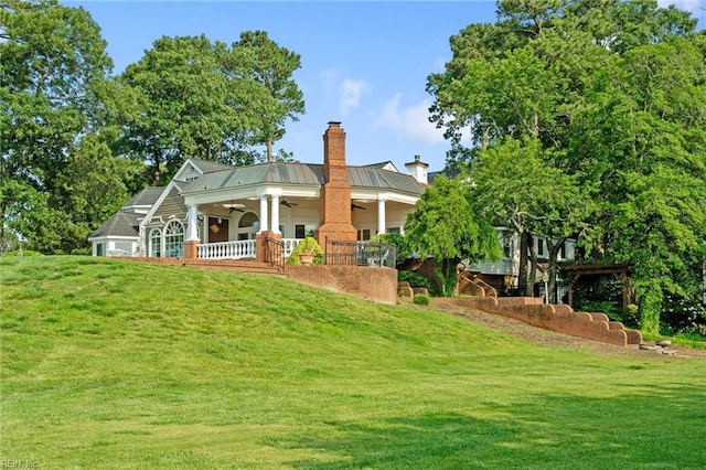 1845 N Alanton Dr, Virginia Beach, VA 23454 - rear view of property featuring a ceiling fan, a chimney, a lawn, and a metal roof