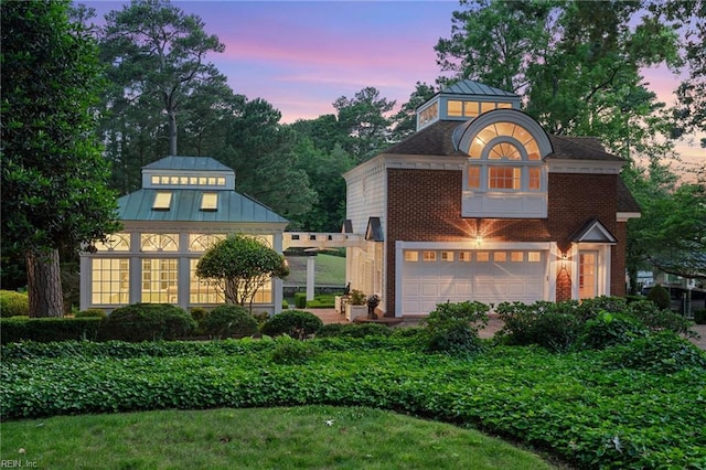 1845 N Alanton Dr, Virginia Beach, VA 23454 - view of front facade with a standing seam roof, an attached garage, a metal roof, and brick siding