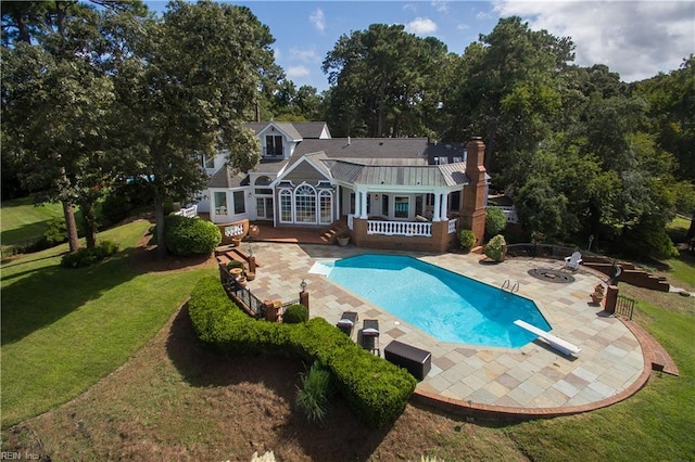 1845 N Alanton Dr, Virginia Beach, VA 23454 - rear view of property featuring a fire pit, a patio, a lawn, an outdoor pool, and a wooden deck