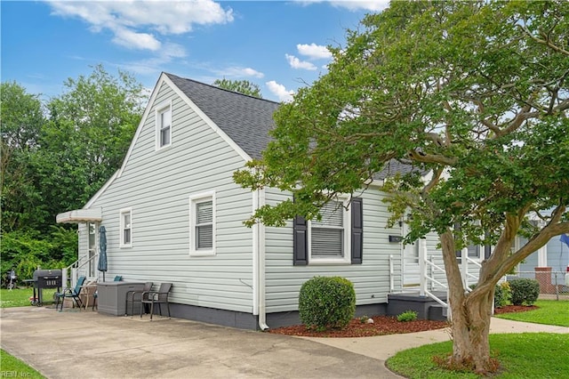 3917 Krick St, Norfolk, VA 23513 - view of side of property with roof with shingles and a patio