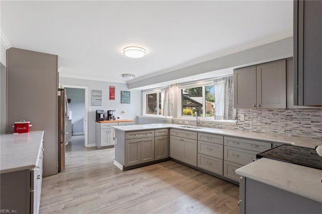 7600 Bridgette Ln, Norfolk, VA 23518 - kitchen with ornamental molding, gray cabinetry, light wood-style floors, light stone counters, and tasteful backsplash