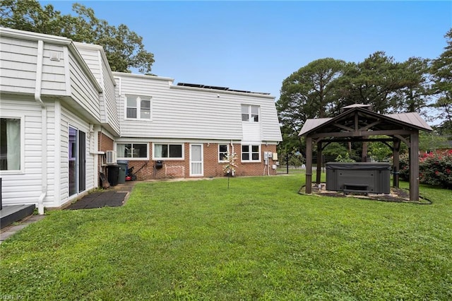 7600 Bridgette Ln, Norfolk, VA 23518 - back of house with a hot tub, a gazebo, brick siding, and a yard